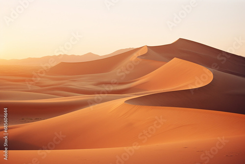 Golden hour photograph of sand dunes in the desert  capturing the shifting shadows and warm hues of a desert sunset.