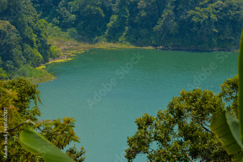 Natural Beauty Of Lake Tamblingan Surrounded By Mountain Forest Trees From Puncak Wanagiri Village, Bali photo