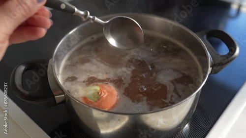 Cook meat broth with vegetables in your home kitchen
