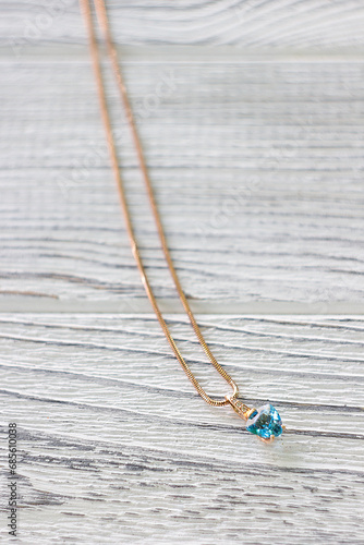 Gold pendant with blue topaz on a gold chain