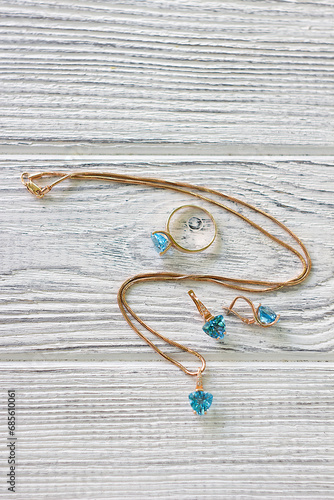 A set of gold jewelry with blue topaz stones