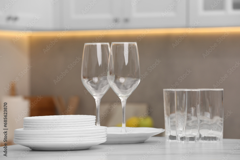 Clean dishes on light table in kitchen Clean dishes on light table in kitchen