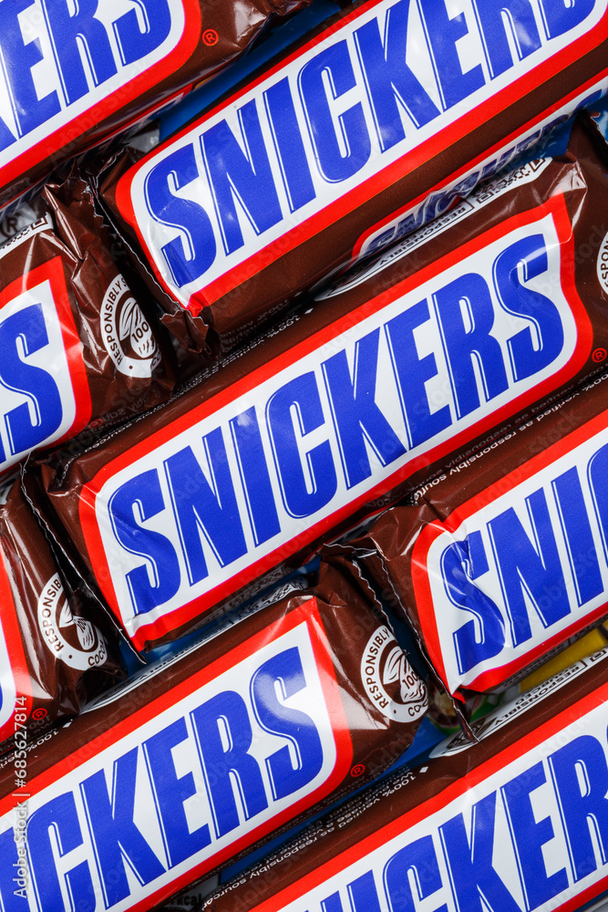 Snickers Brown Background Snickers chocolate bars from Mars Inc. as a background portrait format ...