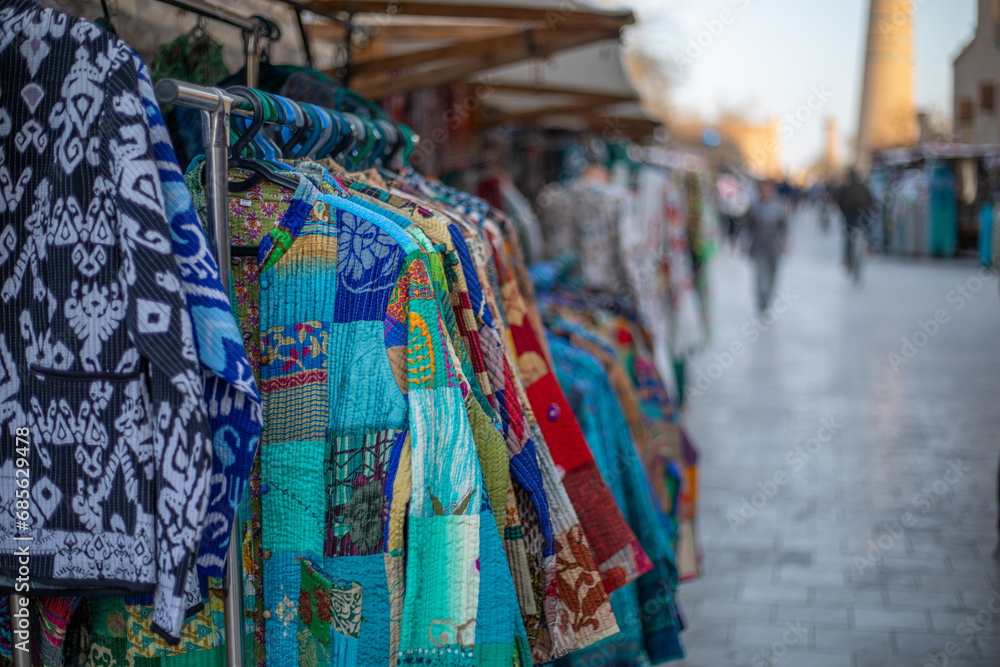a beautiful traditional clothes in a display of outdoor shops, Khiva, the Khoresm agricultural oasis, Citadel.