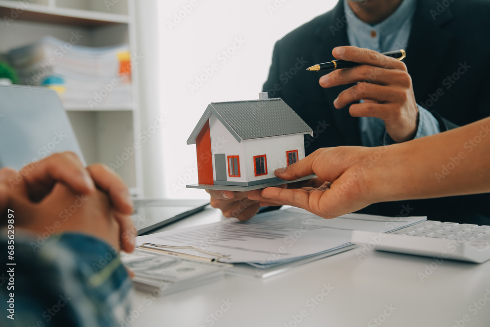 Fototapeta premium Real estate agent and customer signing contract to buy house, insurance or loan real estate.rent a house,get insurance or loan real estate or property.