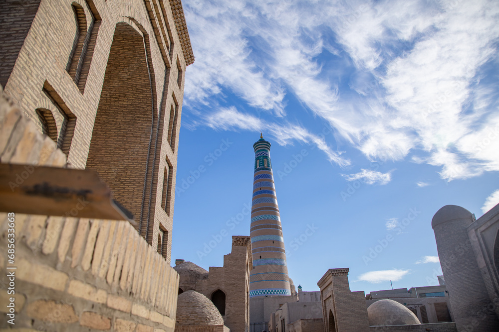 beautiful big tower and a historical building near it, Khiva, the Khoresm agricultural oasis, Citadel.