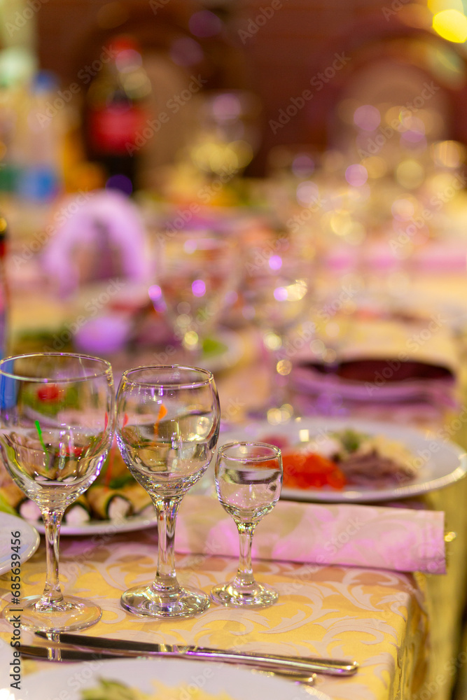 Served festive table with snacks, glasses, glasses, cutlery and napkins for a banquet