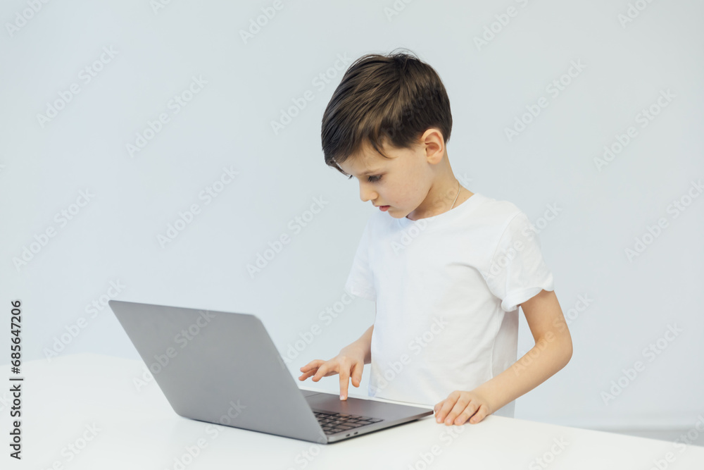 Little boy learns to work on a laptop Little boy learns to work on a laptop