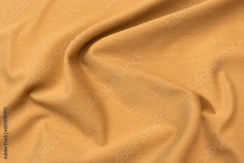 Abstract background texture of natural beige or brown colour fabric. Fabric texture of natural cotton or linen, silk or satin, wool or jersey textile material. Luxurious canvas background..
