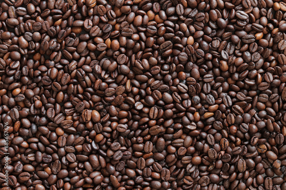 Top view of background representing halves of dark brown coffee beans. Roasted coffee beans, copy space Top view of background representing halves of dark brown coffee beans. Roasted coffee beans, copy space