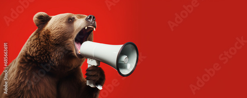 Bear with megaphone announcing the bear market in stocks photo