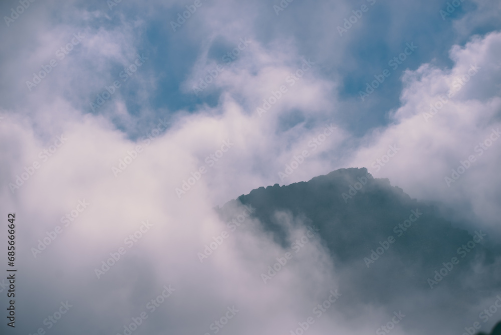 Amazing landscape in Fagaras mountains with spectacular white clouds and blue sky in Romania