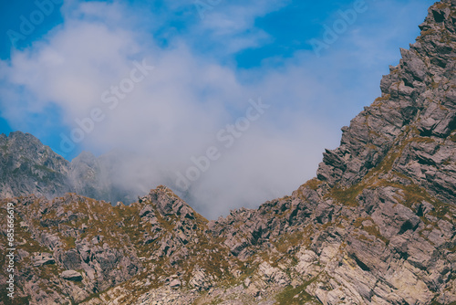 Amazing landscape in Fagaras mountains with spectacular white clouds and blue sky in Romania