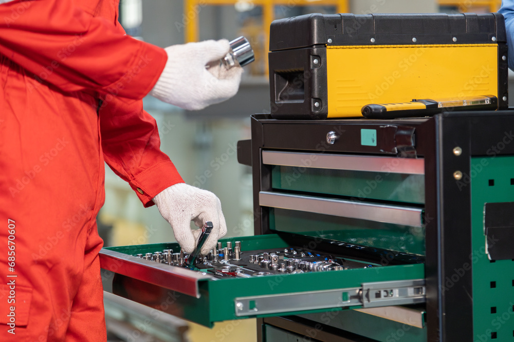 Maintenance engineers select tools for rail work in a railway maintenance center.