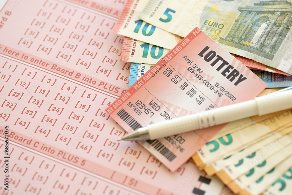 Lottery ticket and gambling receipt on table with pen and European Union euro money bills close up Lottery ticket and gambling receipt on table with pen and European Union euro money bills close up