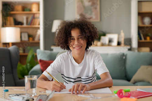 Teenage African-American boy studying at home