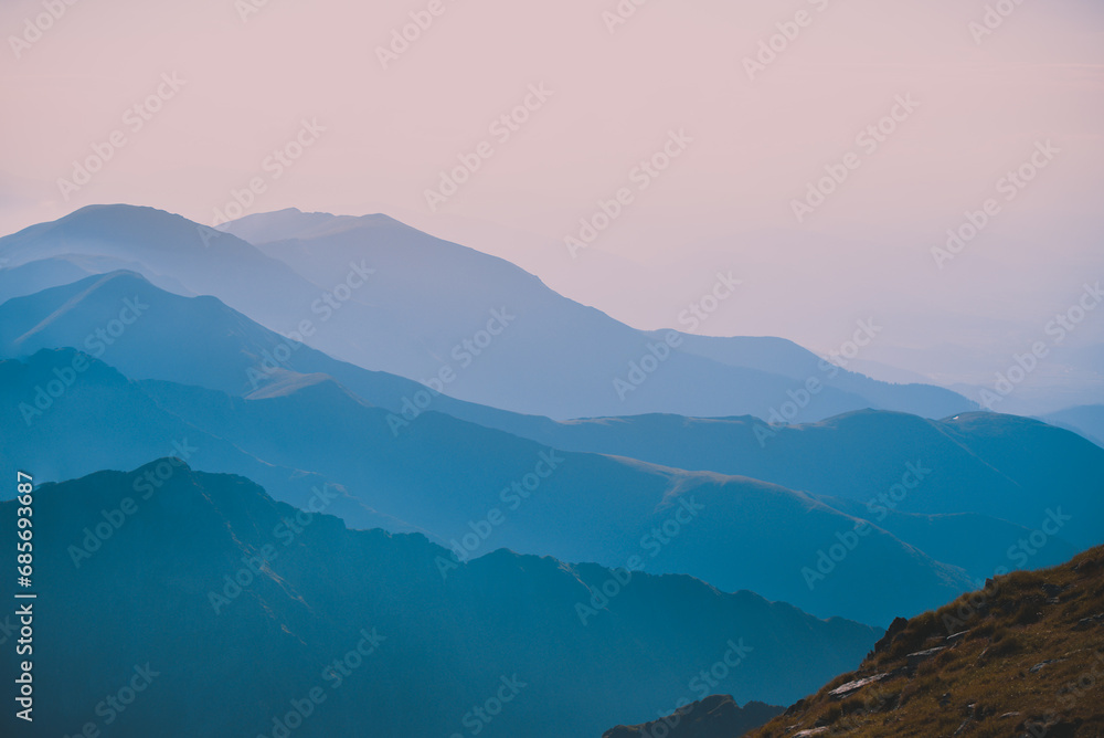 Sharp mountain peaks seen in stunning light from high altitude. Fairy tale landscape with wild Carpathians
