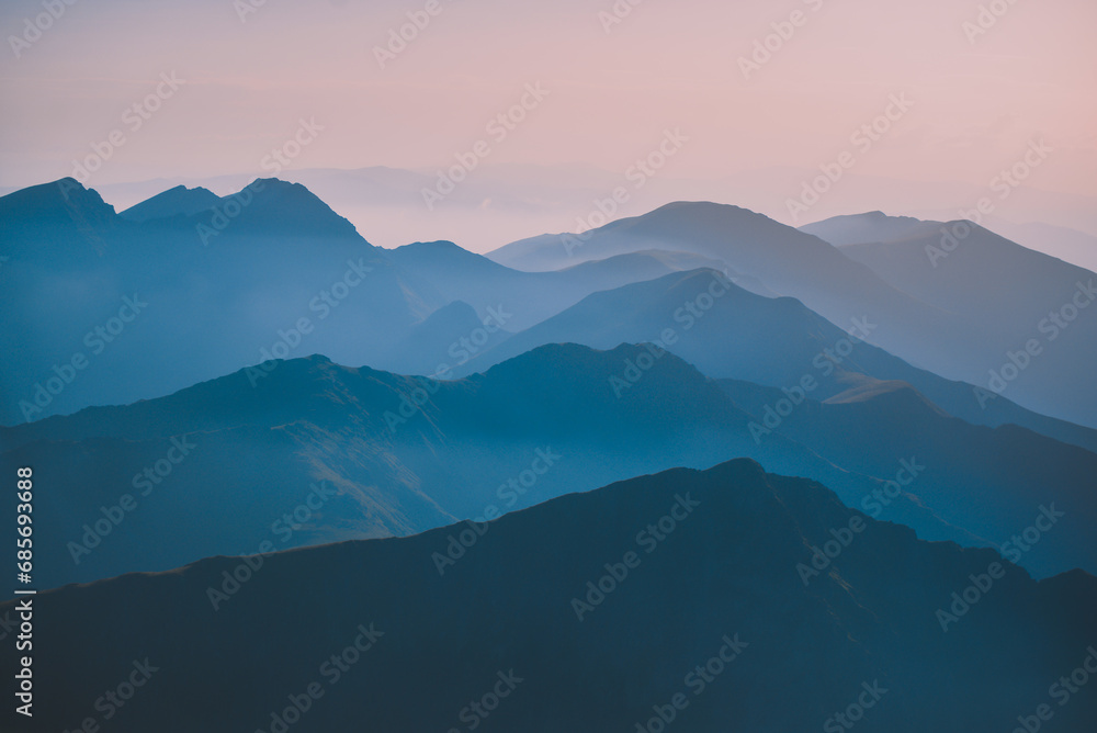 Sharp mountain peaks seen in stunning light from high altitude. Fairy tale landscape with wild Carpathians