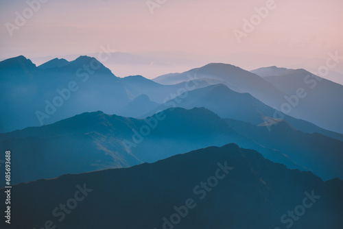 Fototapeta Naklejka Na Ścianę i Meble -  Sharp mountain peaks seen in stunning light from high altitude. Fairy tale landscape with wild Carpathians