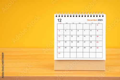 December 2023, Monthly desk calendar for 2023 year on wooden table.