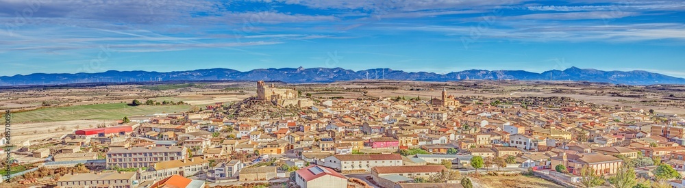 Obraz premium Drone panorama of the village of Almudevar in northern Spain with the Pyrenees in the background