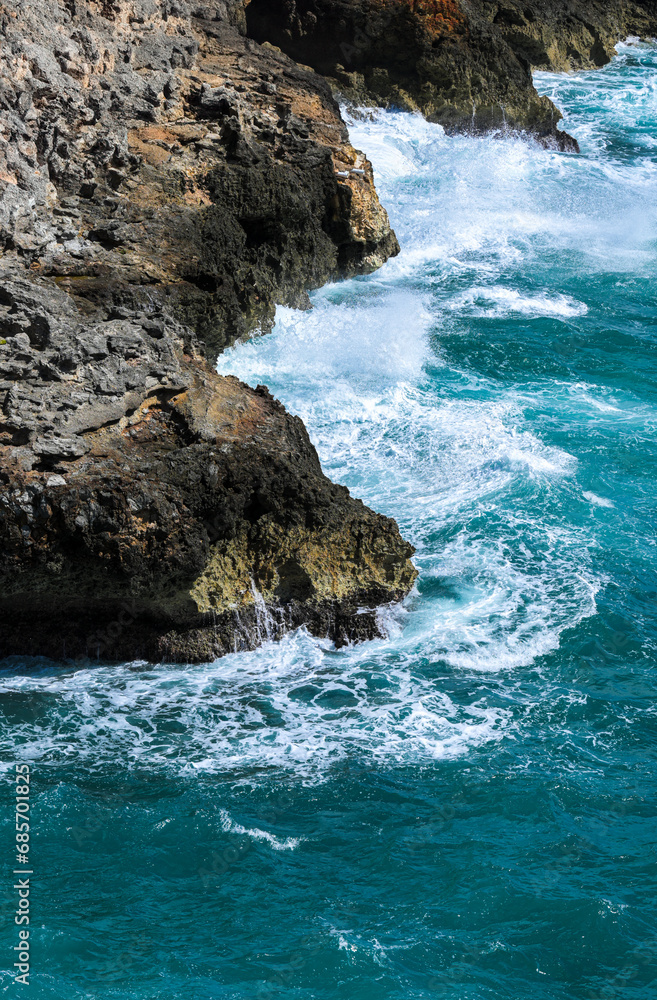 waves crashing and breaking on rocks