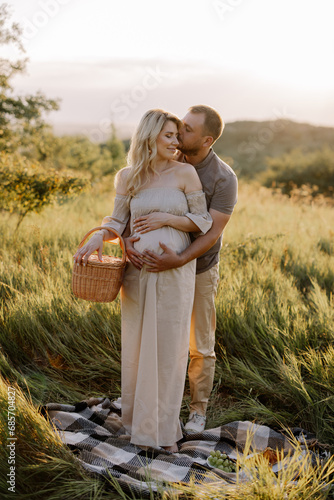 Wallpaper Mural Beautiful young pregnant couple spending time together in outdoor at sunset. The concept of expecting a baby, parenthood. Torontodigital.ca