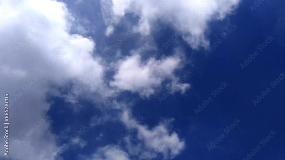 A pile of bright white clouds in the blue sky. A pile of bright white clouds in the blue sky.