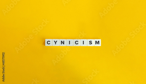 Cynicism Word on Block Letter Tiles on Yellow Background. Minimal Aesthetic. photo