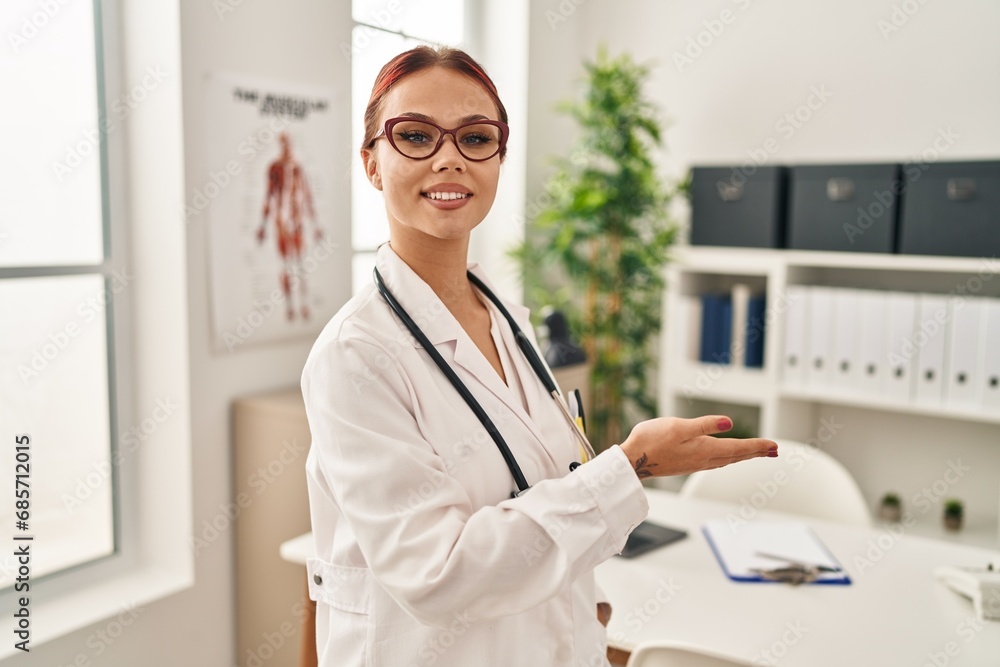 Young caucasian woman doctor smiling confident doing welcome gesture at clinic Young caucasian woman doctor smiling confident doing welcome gesture at clinic