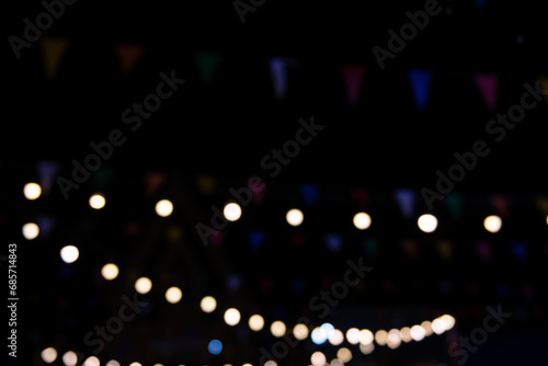 blur of colorful lights in an outdoor amusement park at night. The temple fair is an annual tradition. There is a place for religious ceremonies. and local amusement parks