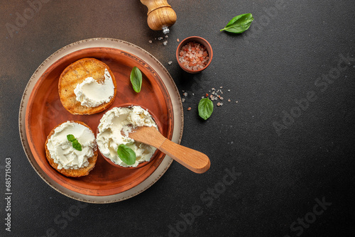 bread with cream cheese on a dark background. banner, menu, recipe copy space, top view