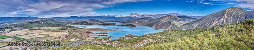 Drone panorama over the Mediano reservoir in the Spanish Pyrenees with snow-covered mountains in the background © Aquarius