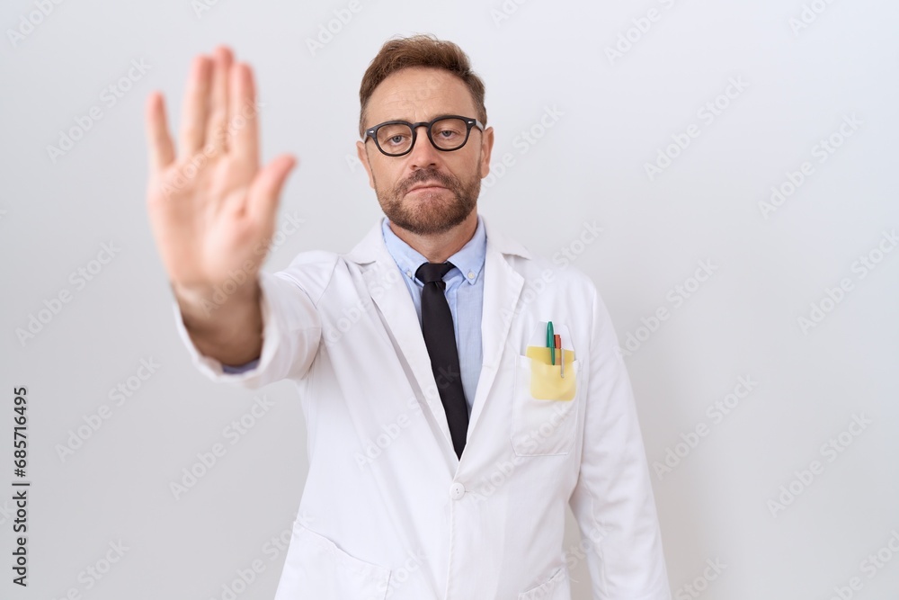 Middle age doctor man with beard wearing white coat doing stop sing with palm of the hand. warning expression with negative and serious gesture on the face. Middle age doctor man with beard wearing white coat doing stop sing with palm of the hand. warning expression with negative and serious gesture on the face.