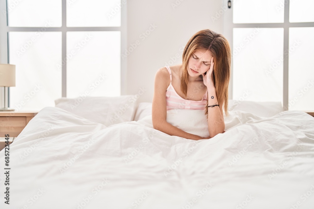 Young blonde woman stressed sitting on bed at bedroom Young blonde woman stressed sitting on bed at bedroom