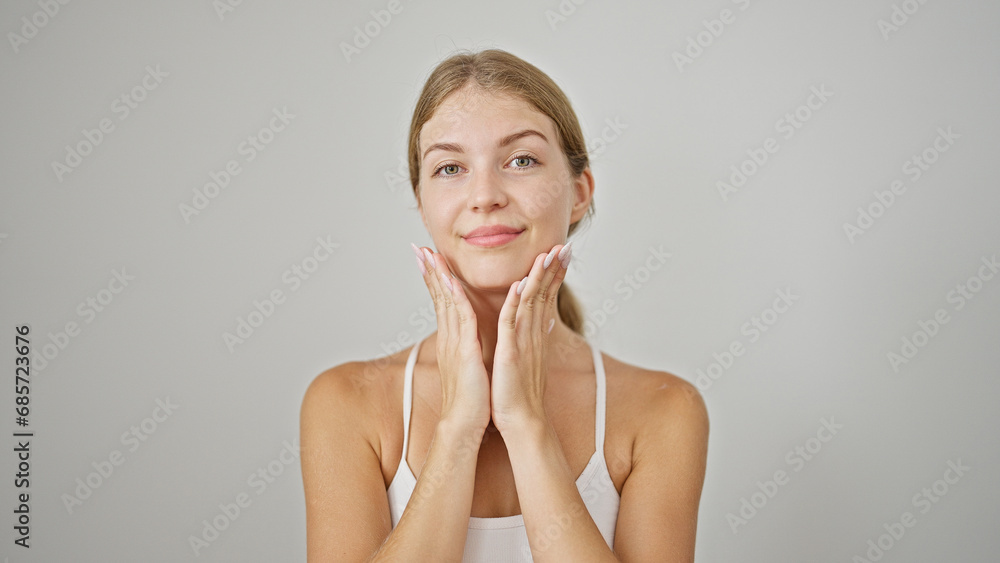 Young blonde woman smiling confident massaging neck over isolated white background Young blonde woman smiling confident massaging neck over isolated white background