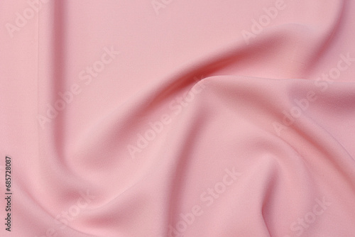 Abstract background texture of natural red color fabric. Fabric texture of natural cotton or linen, silk or satin, wool or jersey textile material. Luxurious red canvas background.