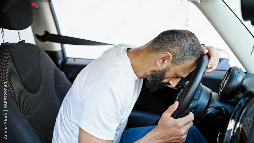 Young hispanic man stressed driving car at street Young hispanic man stressed driving car at street