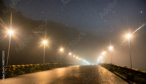 wallpaper of an empty street with lights and stars, foggy night photography, selective focusing; can be used as background