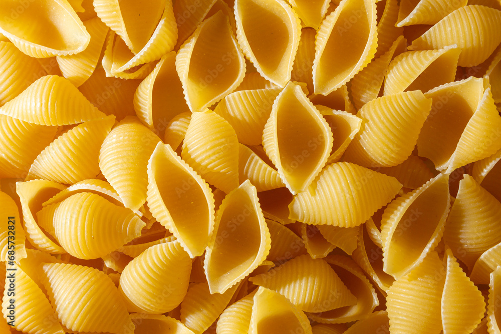 Uncooked Conchiglie Pasta: A Culinary Canvas of Conchiglie Macaroni, Creating a Lively and Textured Background for Gourmet Cooking. Dry Pasta. Raw Macaroni - Top View, Flat Lay Uncooked Conchiglie Pasta: A Culinary Canvas of Conchiglie Macaroni, Creating a Lively and Textured Background for Gourmet Cooking. Dry Pasta. Raw Macaroni - Top View, Flat Lay