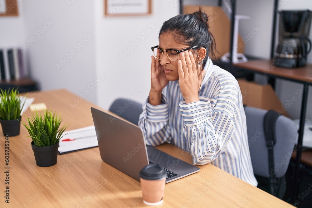 Young beautiful hispanic woman business worker stressed using laptop at office Young beautiful hispanic woman business worker stressed using laptop at office