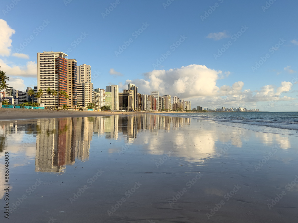 Apartment Buildings are mirroring at the Beach of Candeias and Piedade  early in the morning, just after sunrise. The City of Recife, Brazil is to see in the background. Jaboatao dos Guararapes
