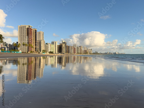 Apartment Buildings are mirroring at the Beach of Candeias and Piedade early in the morning, just after sunrise. The City of Recife, Brazil is to see in the background. Jaboatao dos Guararapes
