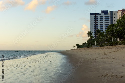 Apartment Buildings are mirroring at the Beach of Candeias early in the morning, just after sunrise.  © Werner