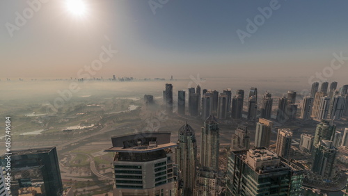 Panorama of Dubai Marina with JLT skyscrapers and golf course during sunrise timelapse, Dubai, United Arab Emirates.