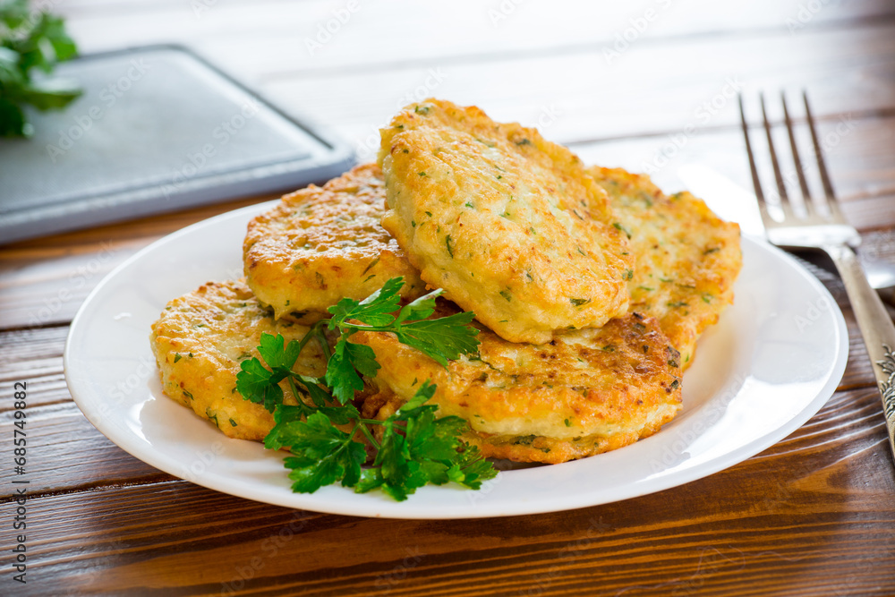 cooked fried potato cutlets with herbs