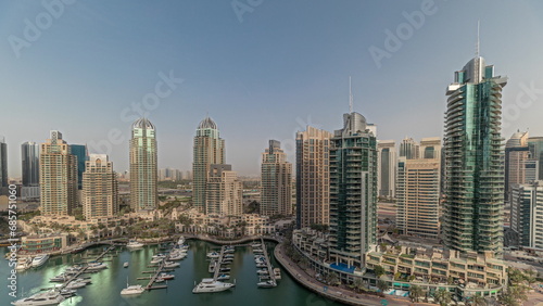 Panorama showing Dubai marina tallest skyscrapers and yachts in harbor aerial timelapse. © neiezhmakov