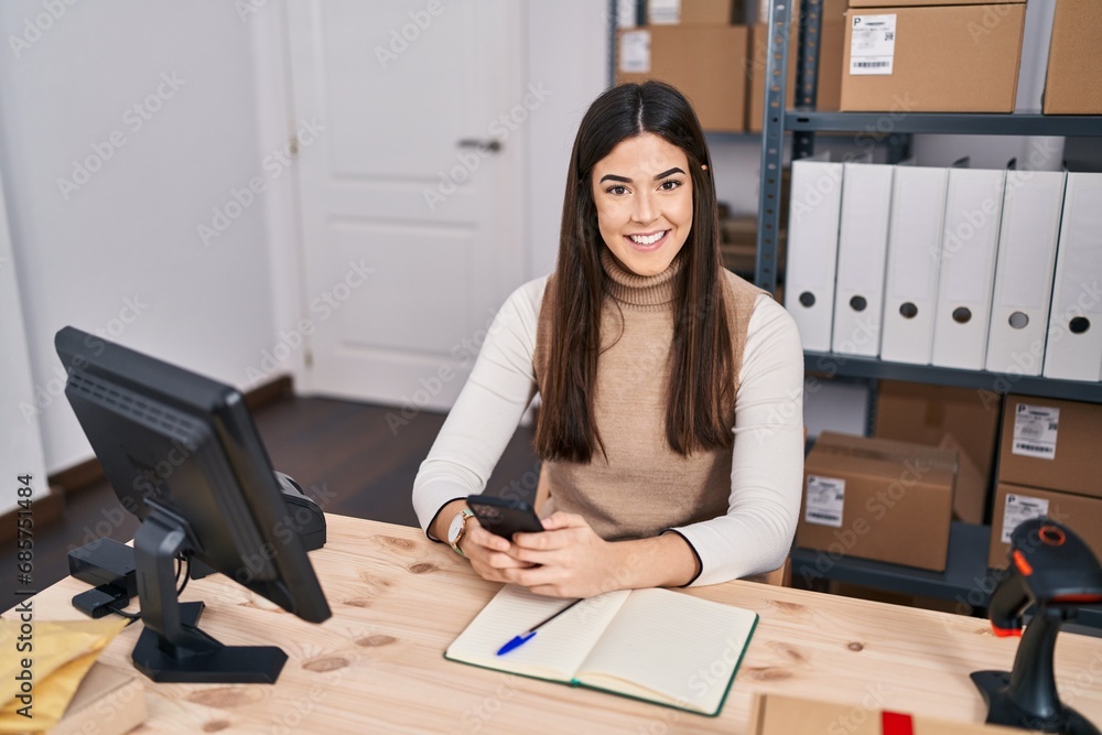 Young beautiful hispanic woman ecommerce business worker using smartphone at office Young beautiful hispanic woman ecommerce business worker using smartphone at office