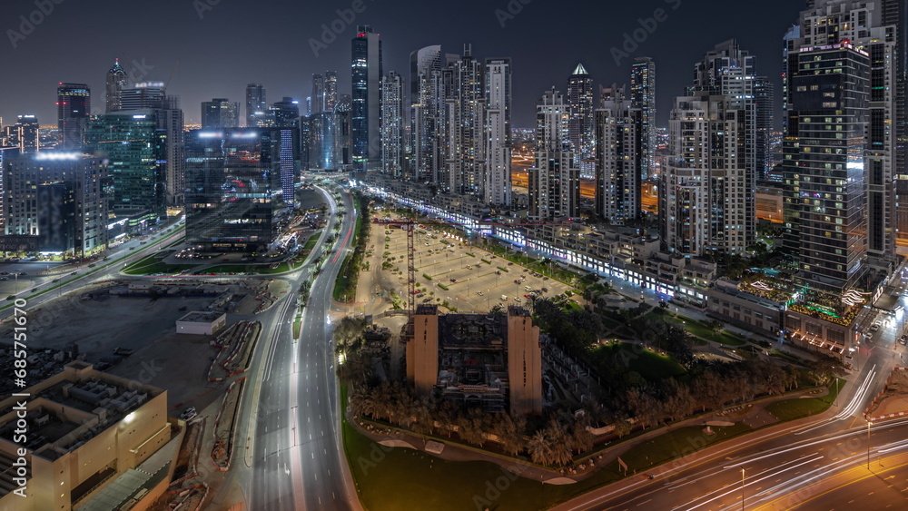 Obraz premium Panorama showing Bay Avenue with modern towers residential development in Business Bay aerial night timelapse, Dubai