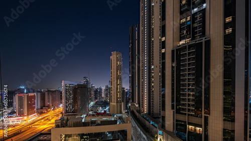 Tallest skyscrapers in downtown dubai located on bouleward street near shopping mall aerial night timelapse. photo